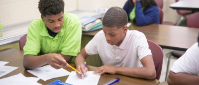 Student helping other student complete work