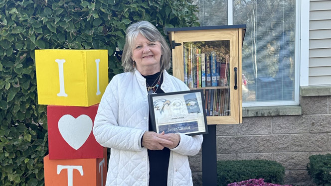 K-8 School in Taylor: Jim Lakatos' wife stands next to library with shadow box.