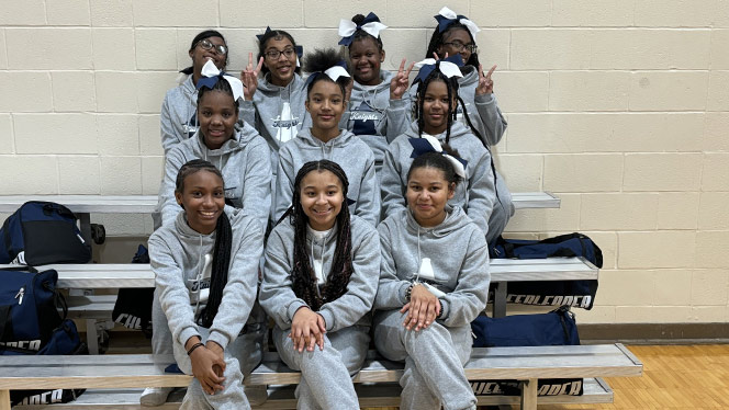 K-8 School in Cincinnati OH: Alliance Cheer team posing inside for photo.