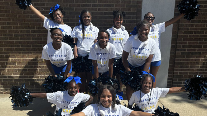 K-8 School in Cincinnati OH: Alliance Cheer team posing outside for photo.