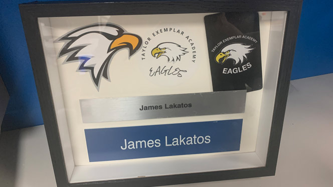 K-8 School in Taylor: Shadow box of James Lakatos' name plates given to his wife.