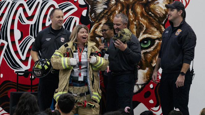 K-8 School in Canton: Canton Charter Principal puts on fireman's suit at Safe Schools Week assembly.