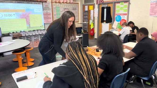 K-8 School in Warren: Great Oaks teacher Ms. Haynes helps her students.