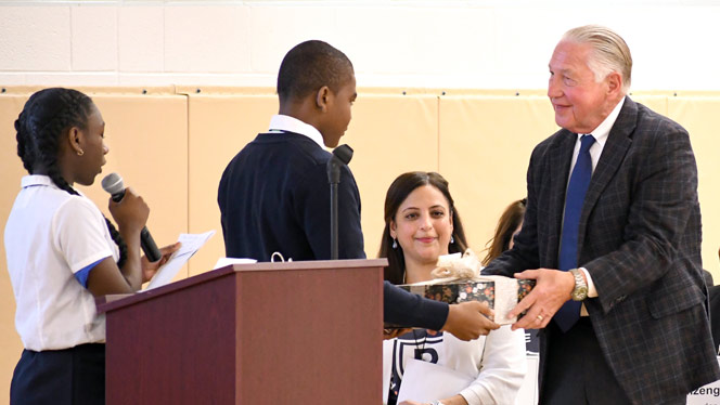 K-8 School in Detroit: Two Pembroke students present NHA Founder with thank you cards from the students.