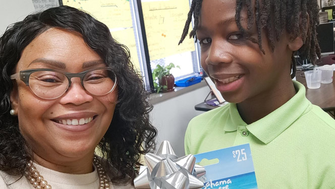 K-8 School in Detroit: Flagship student poses with Ms. Jackson-Clayborn for photo.