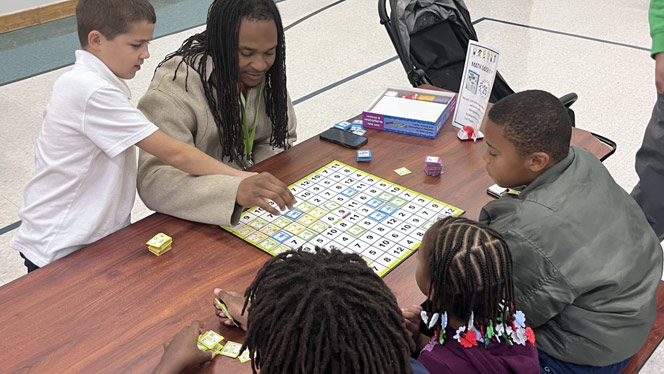 K-8 School in Romulus: Students and parents play board games together at Metro Charter Academy's game night.