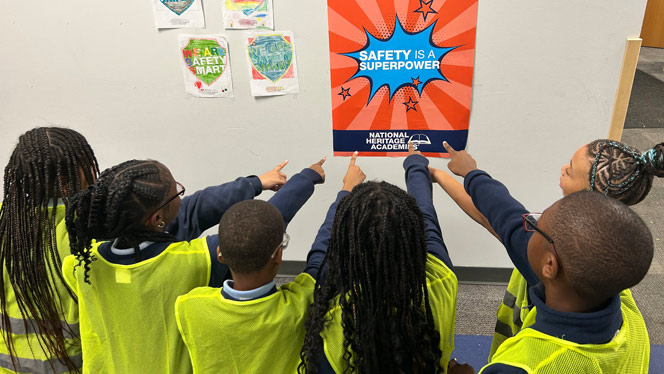 K-8 School in Mount Clemens: Prevail students point to "Safety is a Superpower" poster during Safe Schools Week.