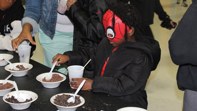 K-12 School in Waterford: Student wearing a Spiderman mask participating in game at SCREAM night.