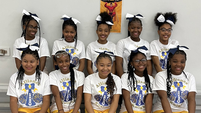 K-8 School in Cincinnati OH: Alliance Cheer team posing inside for photo.