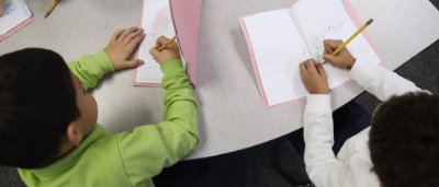 Two students completing work