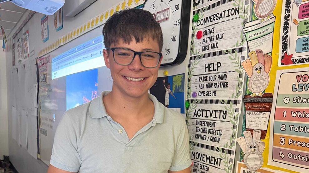 Student smiling in front of class
