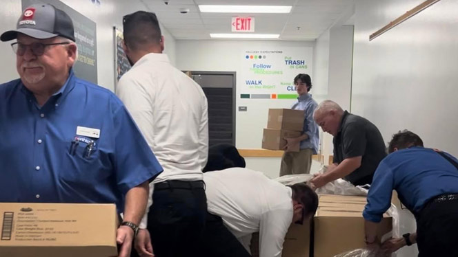 K-8 School in Buffalo NY: Volunteers from Northtown Toyota and the KINF open boxes of supplies.