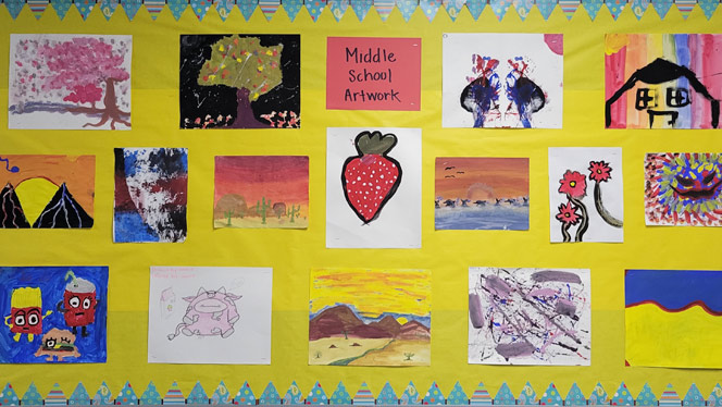 K-8 School in Colorado Springs: Middle school artwork hung in hallway on bulletin board.