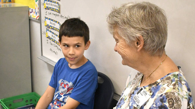 K-8 School in Wyoming: Residents of Waterford Place visit Vanguard every two weeks to help students with reading.