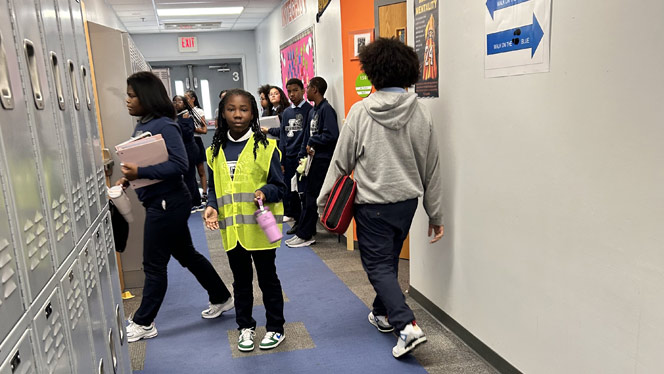 K-8 School in Mount Clemens MI: Safety specialist stands in hallway between classes.