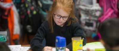 Student completing work in classroom