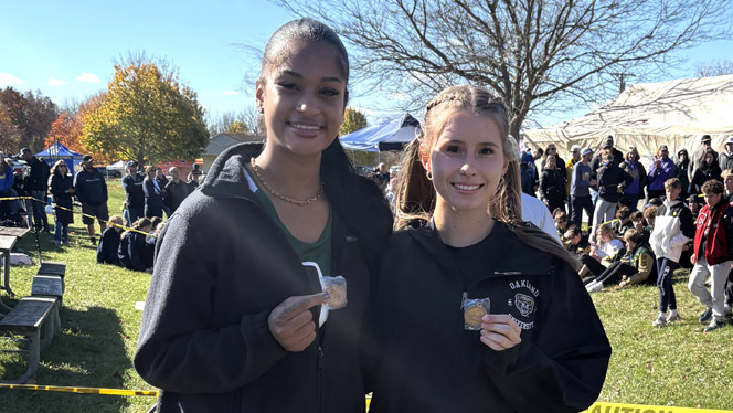 High School in Ypsilanti: Pernell and Bush holding up medals for competing in the state finals.