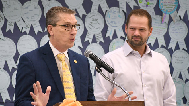 K-8 School in Belmont: State Sen. Mark Huizenga, left, and State Rep. Bryan Posthumus congratulate Chandler Woods.