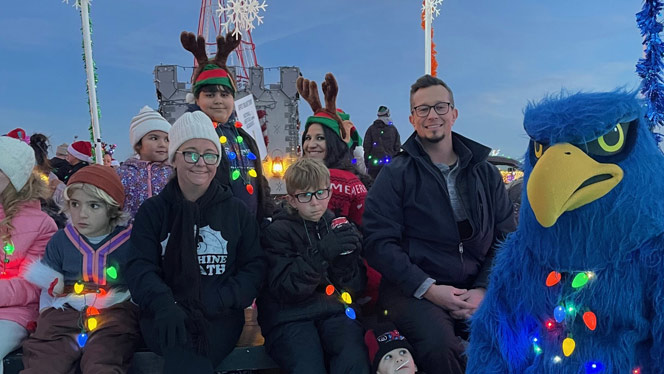 K-8 School in Brighton: Staff, students, and parents from Landmark sit on float in parade.