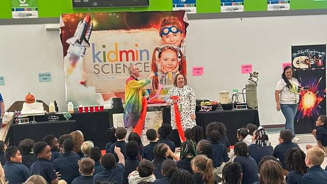 K-8 School in Dayton: Families participate in assembly with The Amazing Chemist.