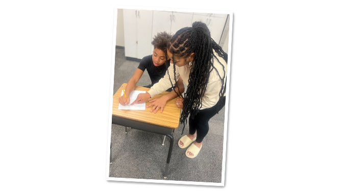 K-8 School in Romulus MI: Metro Charter Academy teacher helping a student.