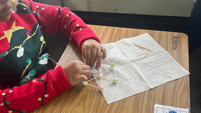 K-8 School in Detroit: Detroit Merit student works on their snowflake design.