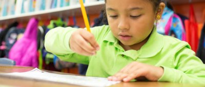 Student completing work in classroom
