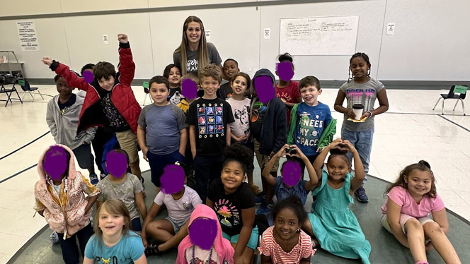 K-8 School in Grand Rapids: Anthony poses with her class.