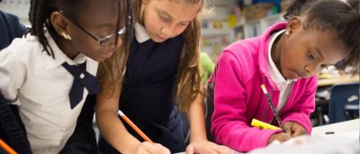 Three students completing work