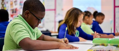 Advantage Charter Academy, K-8 Charter School in Baker, Louisiana: kids sitting in class writing on papers with pencils.