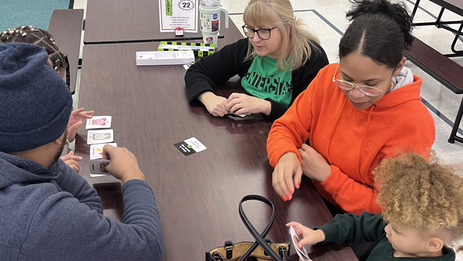 K-8 School in Romulus: Students and parents play board games together at Metro Charter Academy's game night.