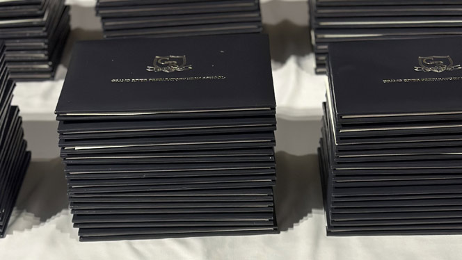 High School in Kentwood MI: Stacks of Grand River Prep diplomas.