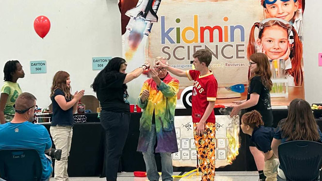 K-8 School in Dayton: Families and students participate in assembly with The Amazing Chemist.