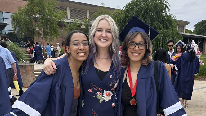 High School in Kentwood MI: Grand River Prep school counselor Schumacher-Smith takes photos with high school graduates.