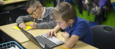 Two students completing work in classroom