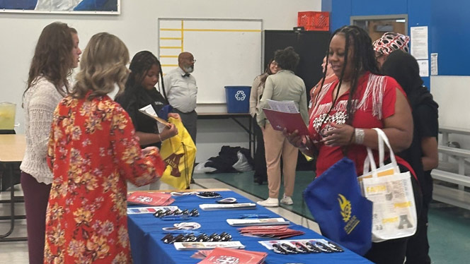 K-8 School in Dayton: Parent and student at booth.