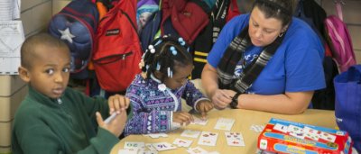 Teacher helps two students learn
