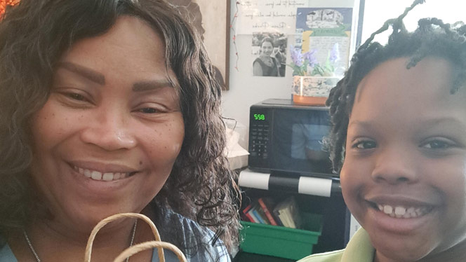 K-8 School in Detroit: Flagship student poses with Ms. Jackson-Clayborn for photo.