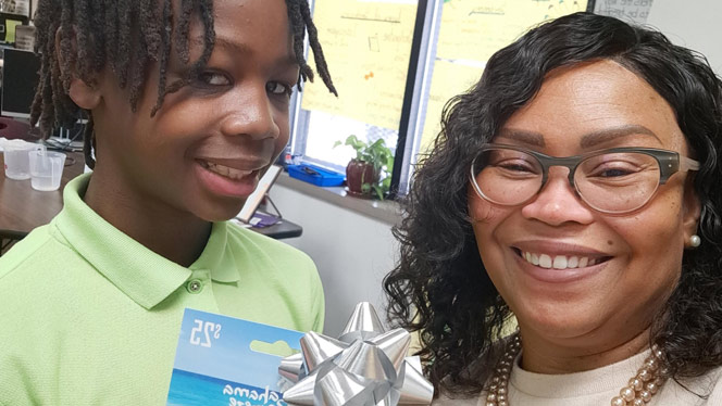 K-8 School in Detroit: Flagship student poses with Ms. Jackson-Clayborn for photo.