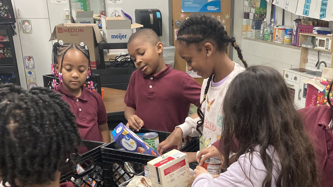 K-8 School in Warren: The Great Oaks Community Changers sort cans from their food drive.