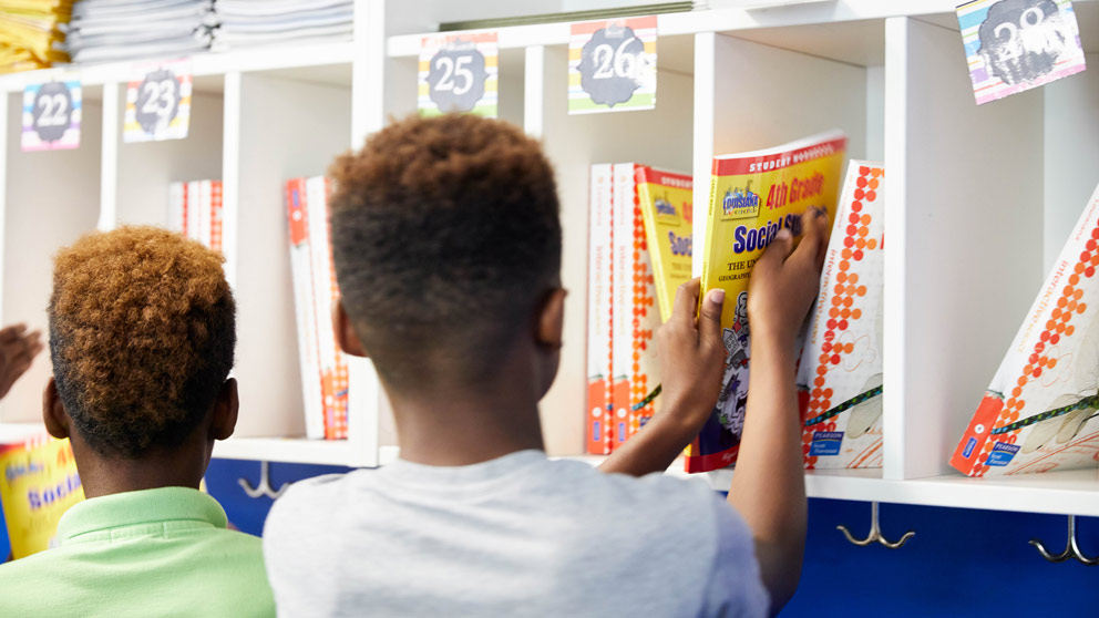 Student putting book in locker