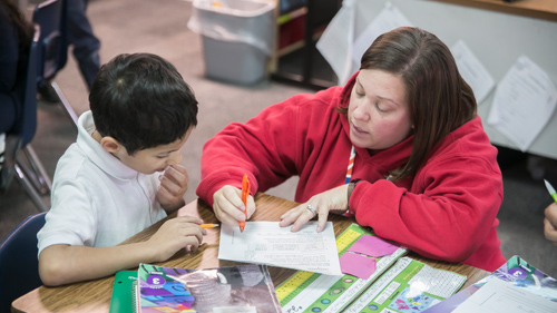 Student raising his hand in class