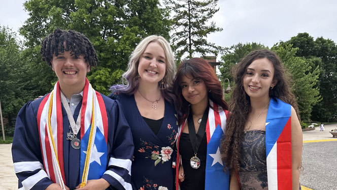 High School in Kentwood MI: Grand River Prep school counselor Schumacher-Smith takes photos with high school graduates.