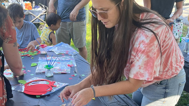 K-8 School in Winston-Salem NC: Families participate in crafts at a craft booth.