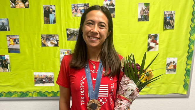 K-8 School in Grand Rapids: Alena Olsen, USA Rugby Team member, posing with bronze medal and flowers.