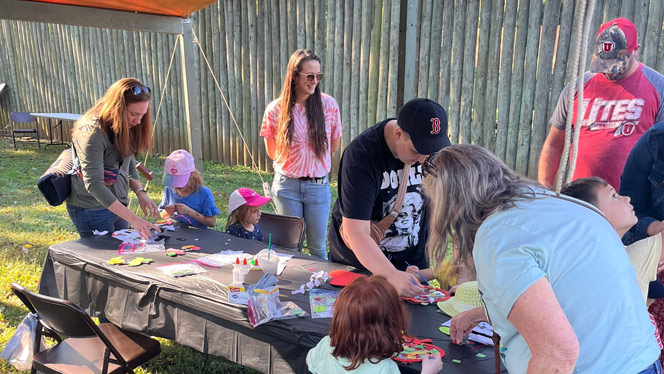 K-8 School in Winston-Salem NC: Families participate in activities at craft booth.