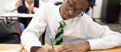 Student completing work in classroom